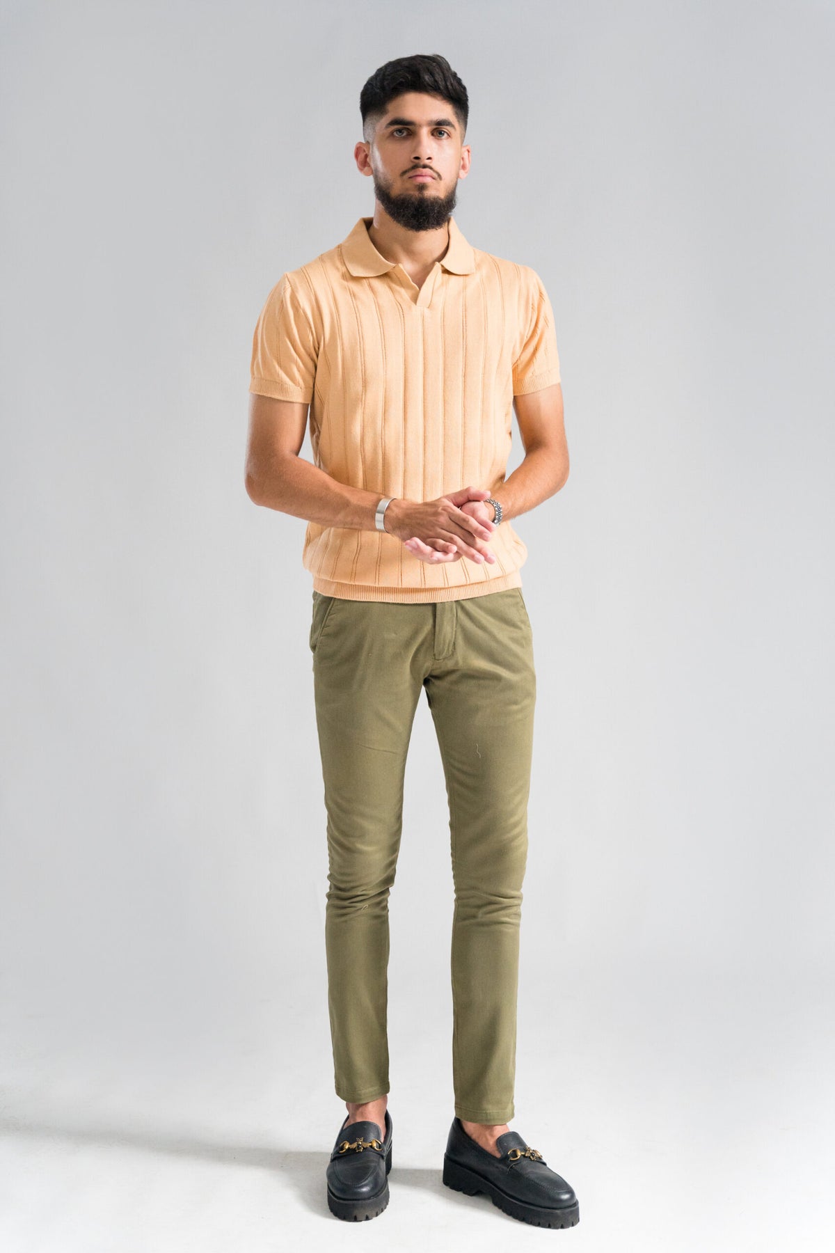 Wear Anarchy Apricot Knitted Polo for men styled with olive trousers and black loafers