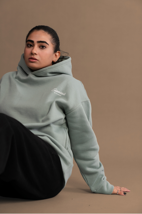 Wear Anarchy Aqua Green Essential Hoodie in a relaxed seated look with long sleeves and embroidered chest logo