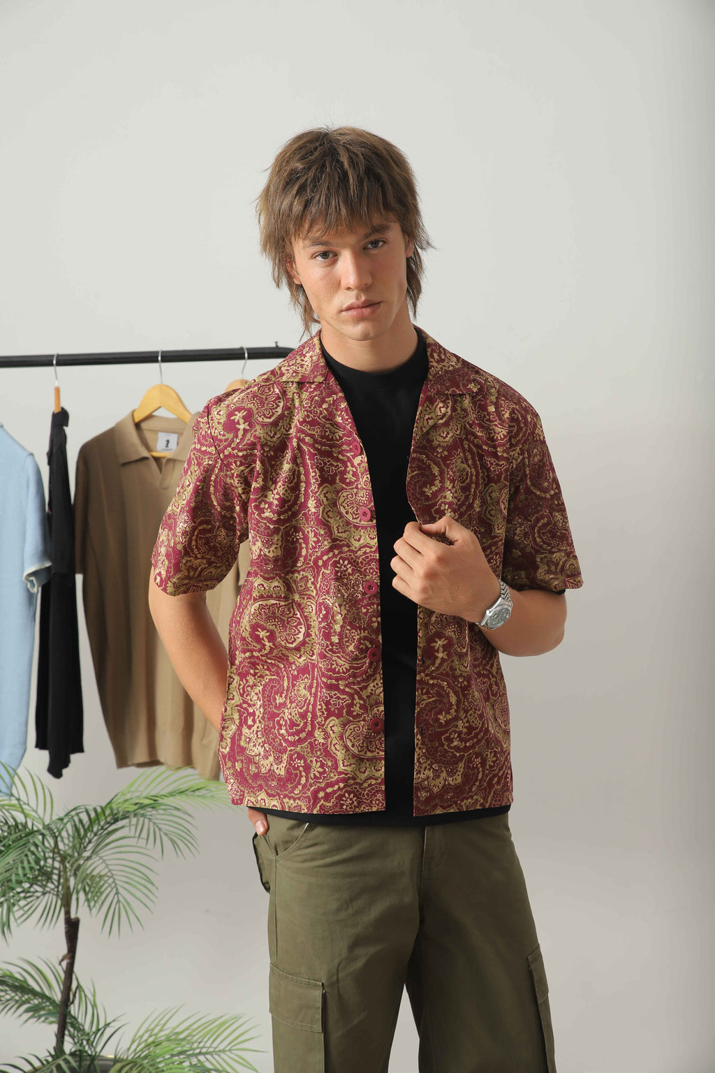 Wear Anarchy bandana print resort shirt for men with short sleeves and open camp collar layered over a black t-shirt