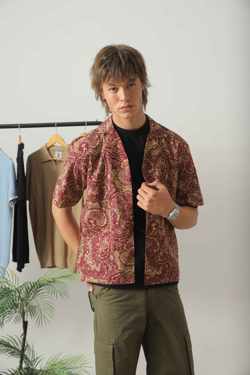 Wear Anarchy bandana print resort shirt for men with short sleeves and open camp collar layered over a black t-shirt