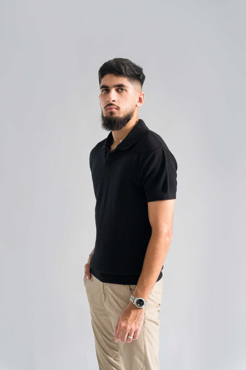 Side view of Wear Anarchy Black Knitted Polo for men with textured knit fabric, short sleeves and open collar