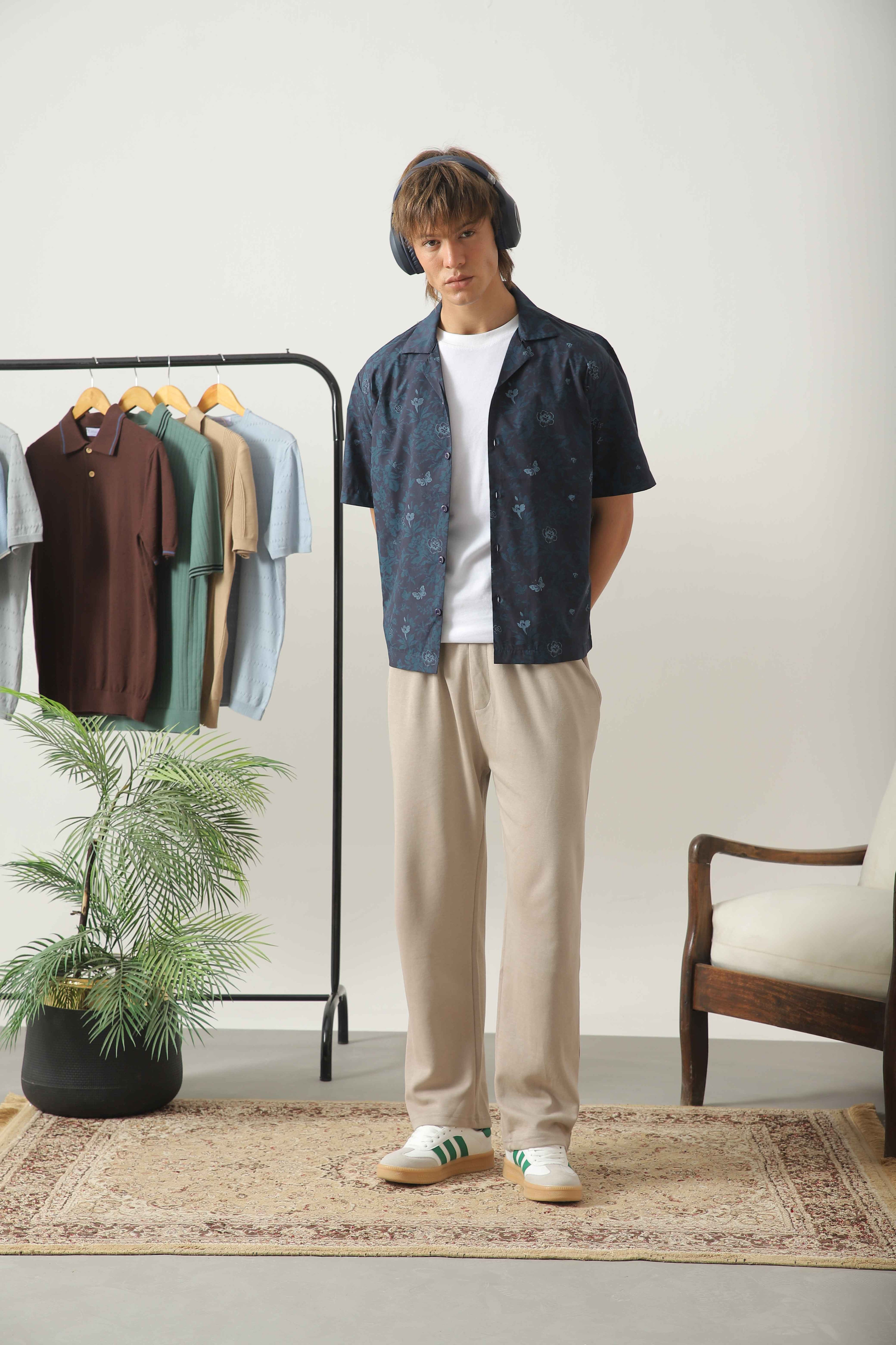Wear Anarchy blue print resort shirt for men styled over a white t-shirt with beige trousers and sneakers