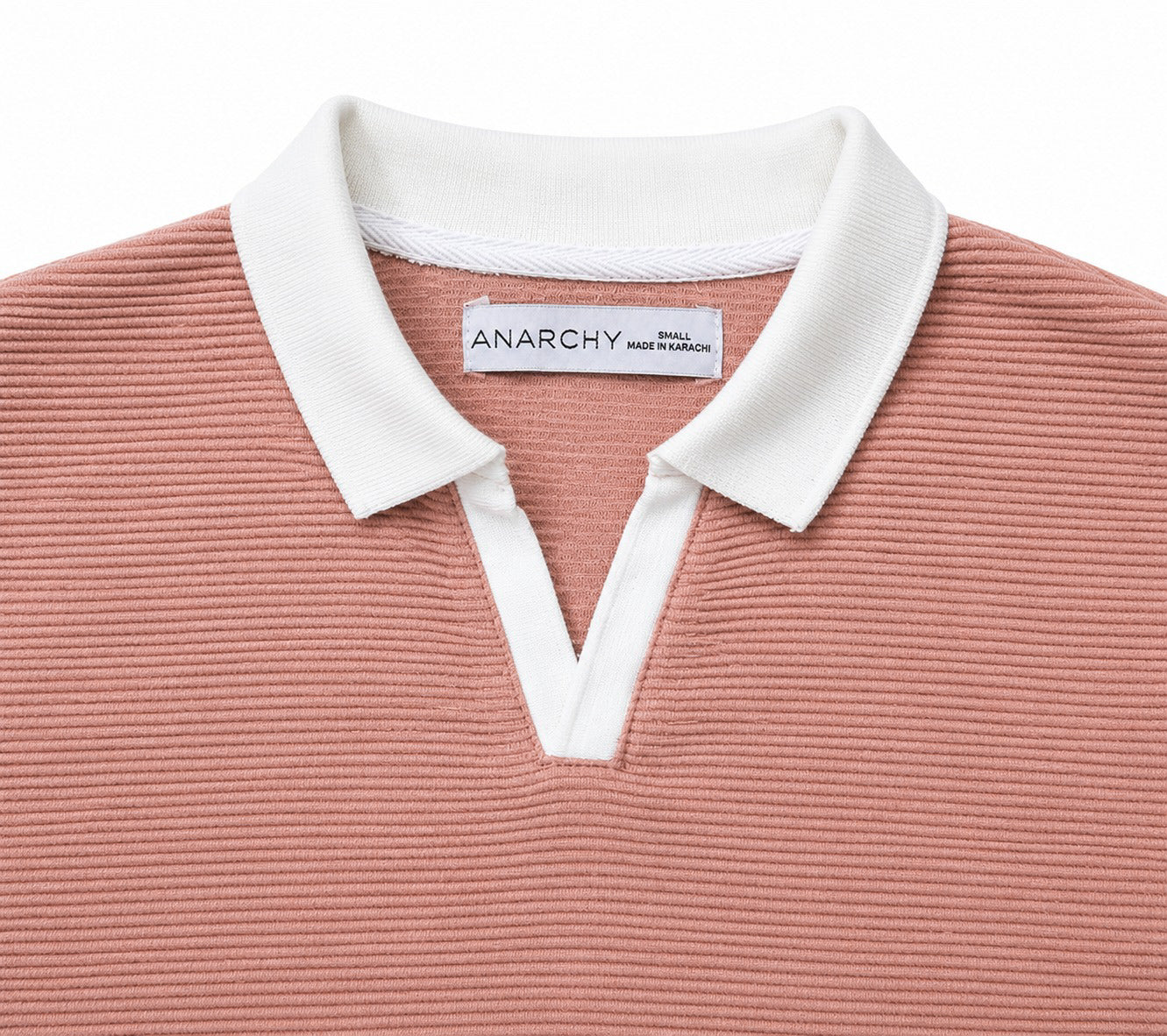 Close-up of Wear Anarchy dusty pink textured polo shirt with white contrast collar and V-neck placket