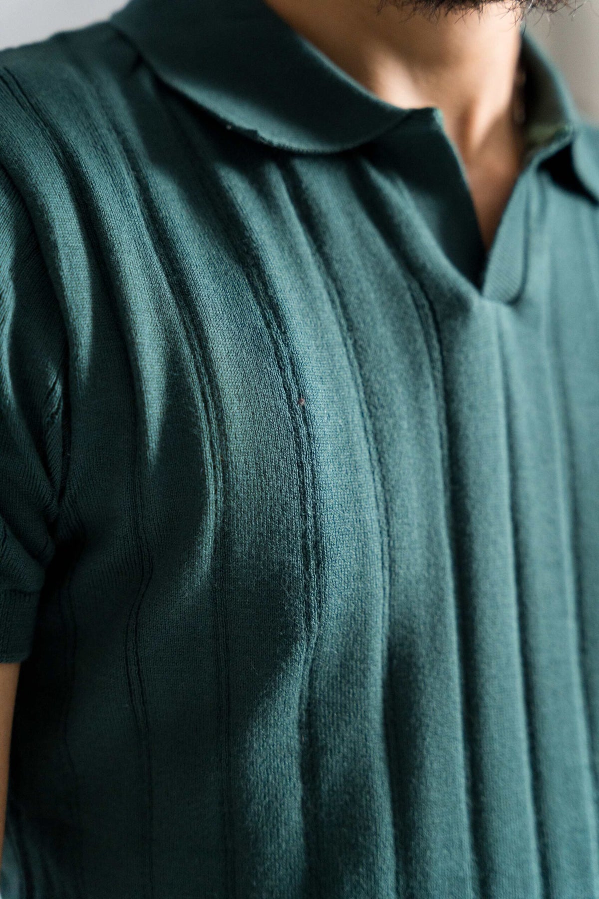 Close-up of Wear Anarchy Forest Green Knitted Polo showing open collar and vertical textured knit detailing