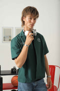 Wear Anarchy green golf resort shirt for men with short sleeves, open collar and embroidered chest details