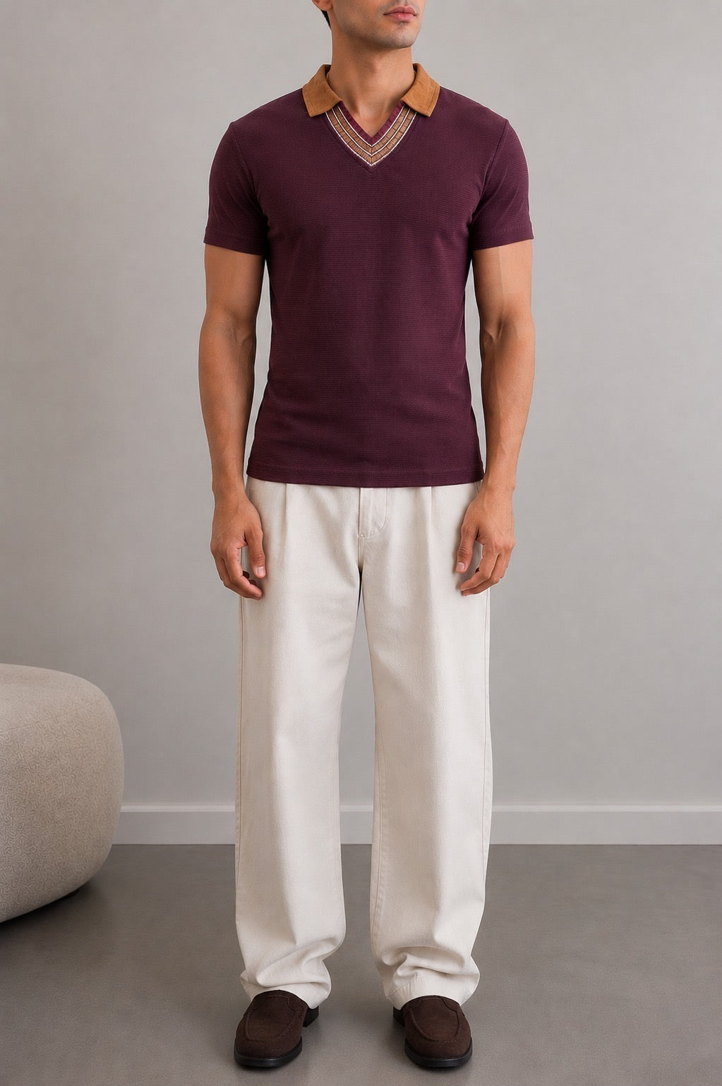 Wear Anarchy maroon polo shirt for men with camel collar and striped V-neck trim styled with off-white trousers