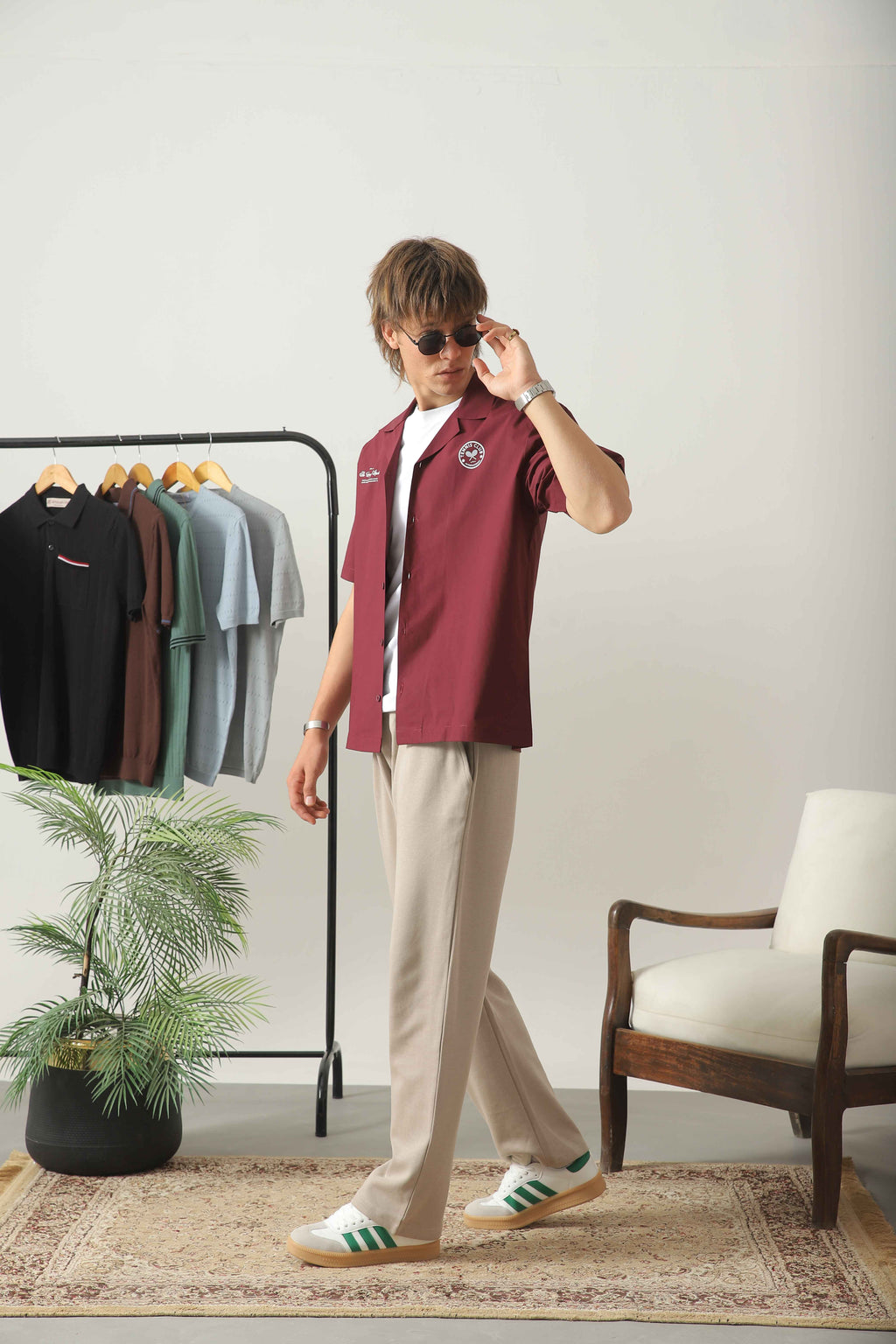 Wear Anarchy maroon golf resort shirt for men styled with beige trousers and white sneakers