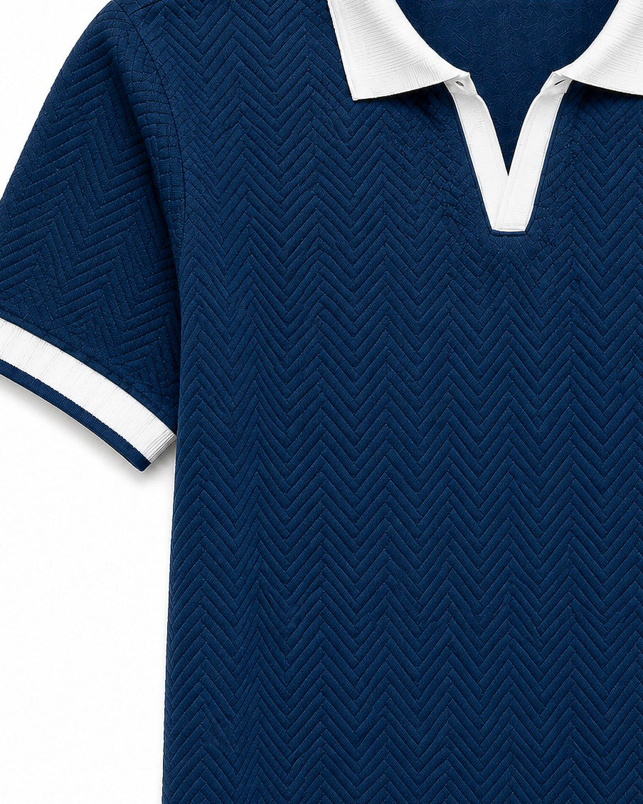 Close-up of Wear Anarchy navy blue herringbone textured polo shirt with white contrast collar and sleeve trim