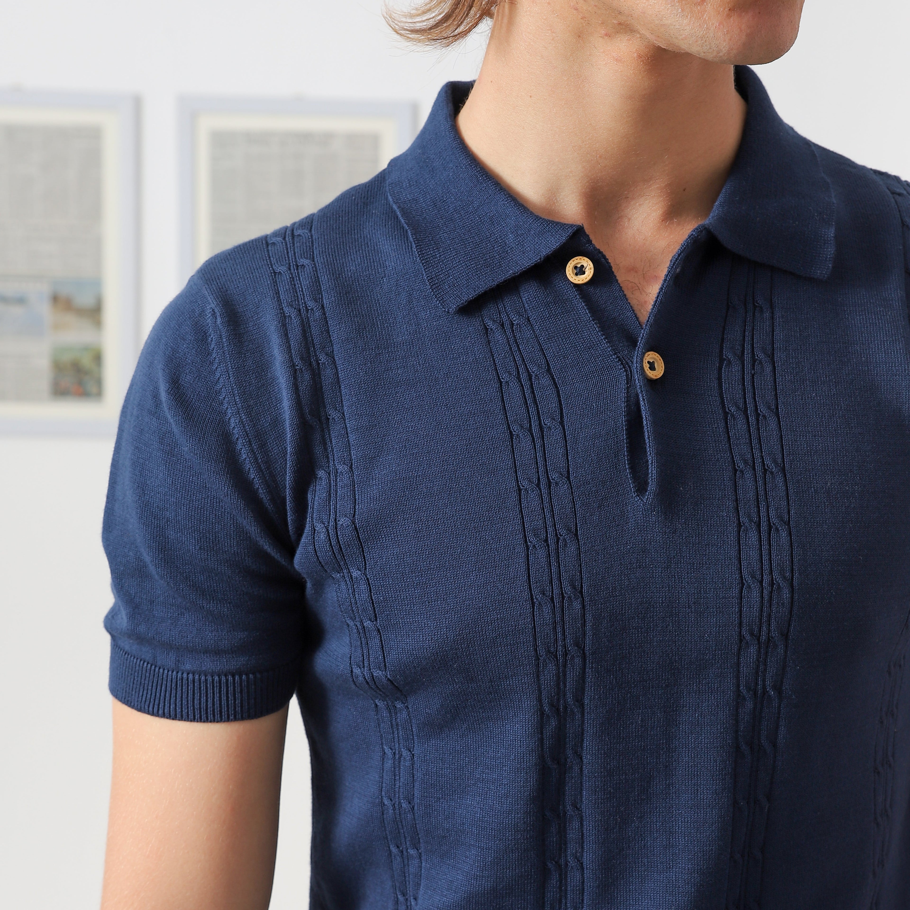 Close-up of Wear Anarchy navy blue textured knit polo shirt showing collar, button placket and vertical knit detailing