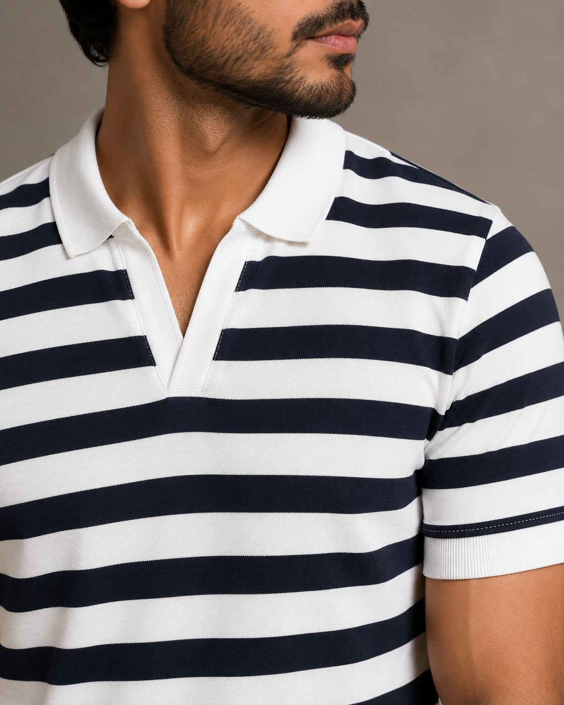Close-up of Wear Anarchy navy and white striped polo shirt with white contrast collar and V-neck placket