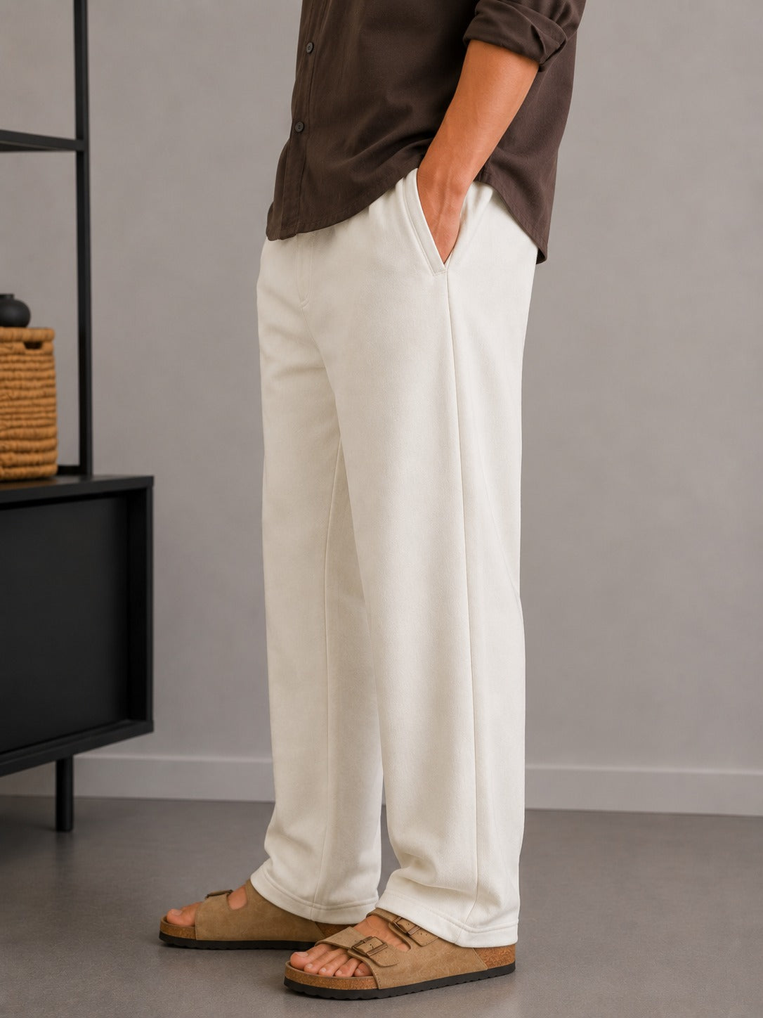Side view of Wear Anarchy off-white terry trousers for men with a relaxed straight-leg fit
