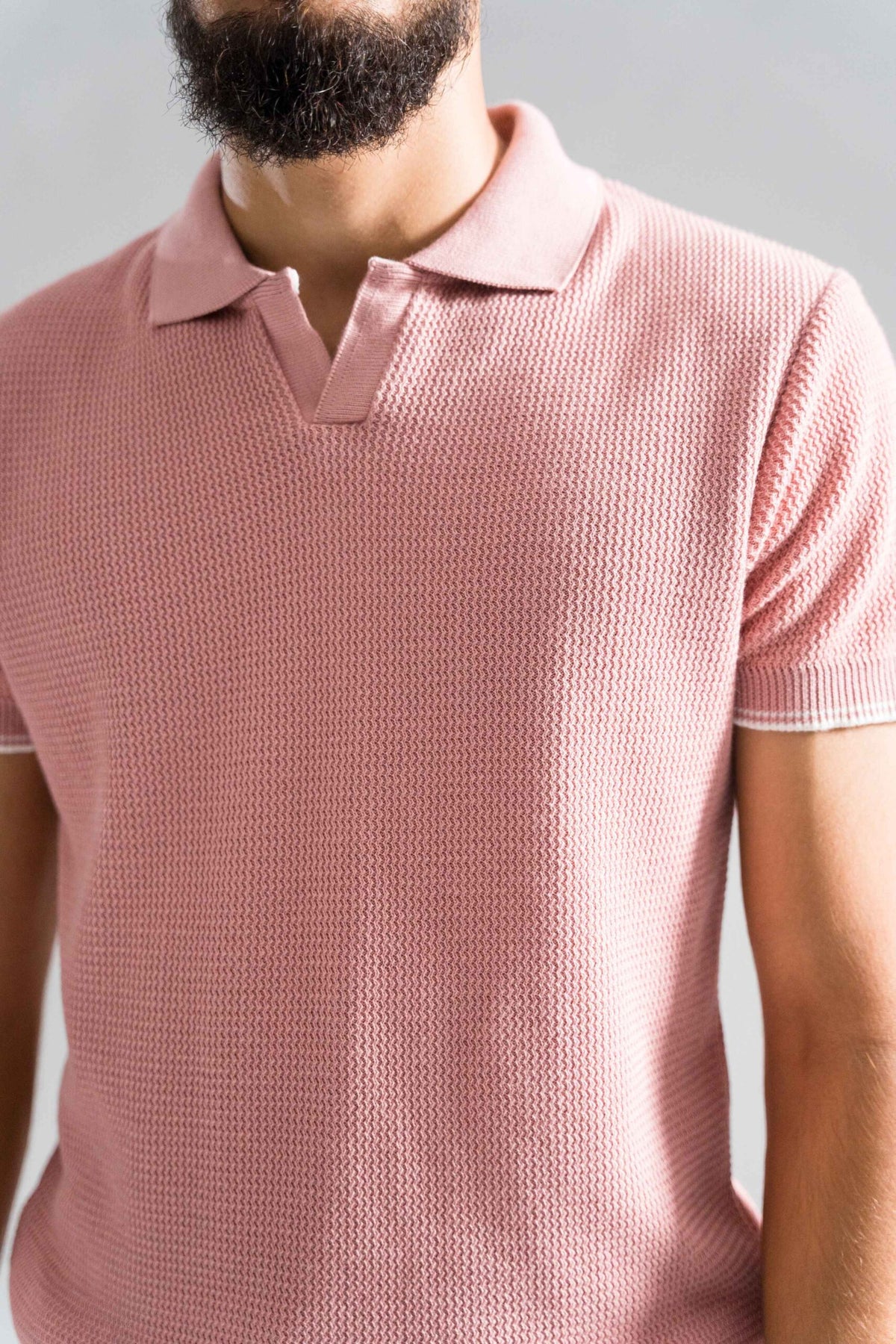 Close-up of Wear Anarchy Pink Knitted Polo showing open collar and textured knit fabric detail