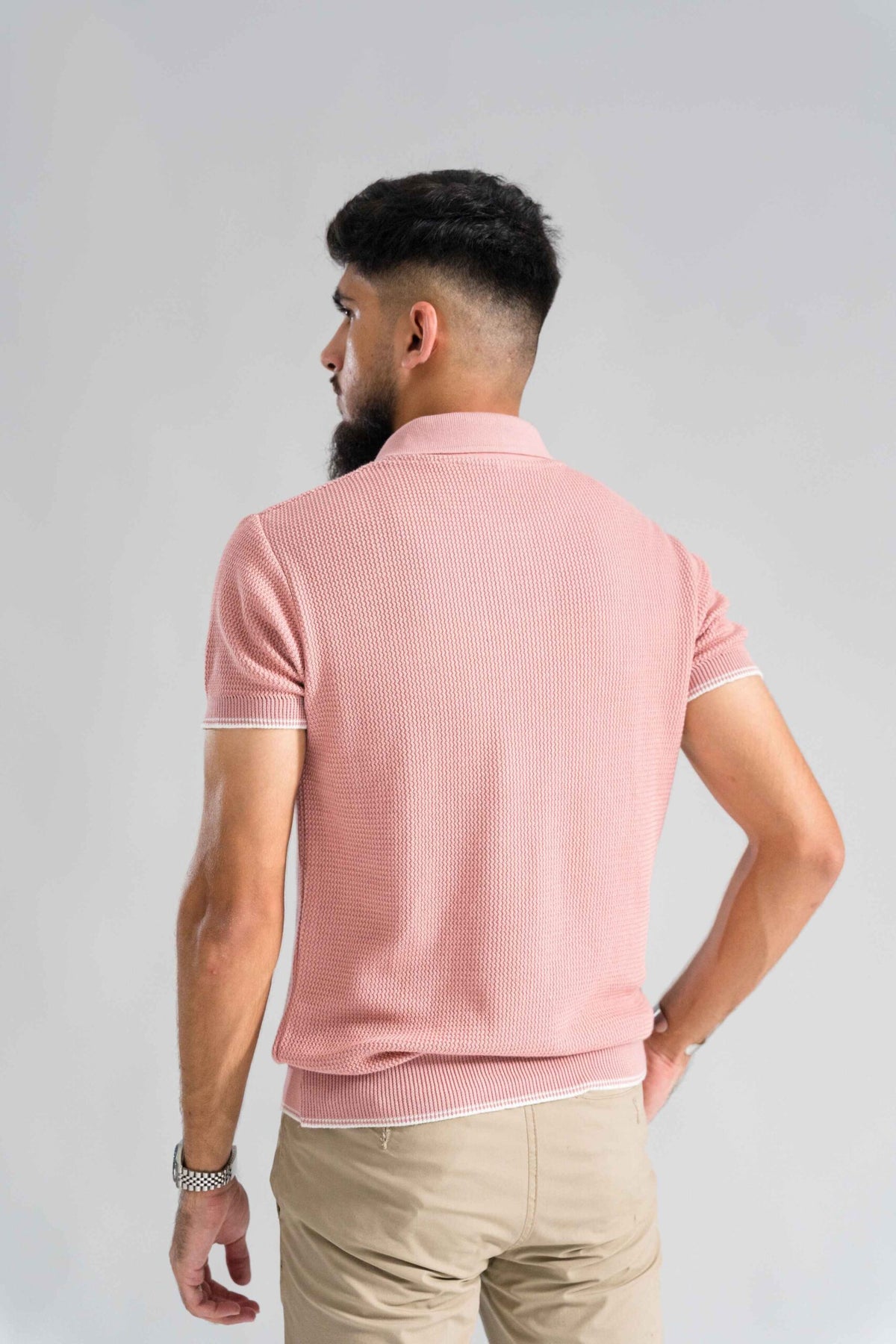 Back view of Wear Anarchy Pink Knitted Polo for men showing textured knit fabric, short sleeves and ribbed hem