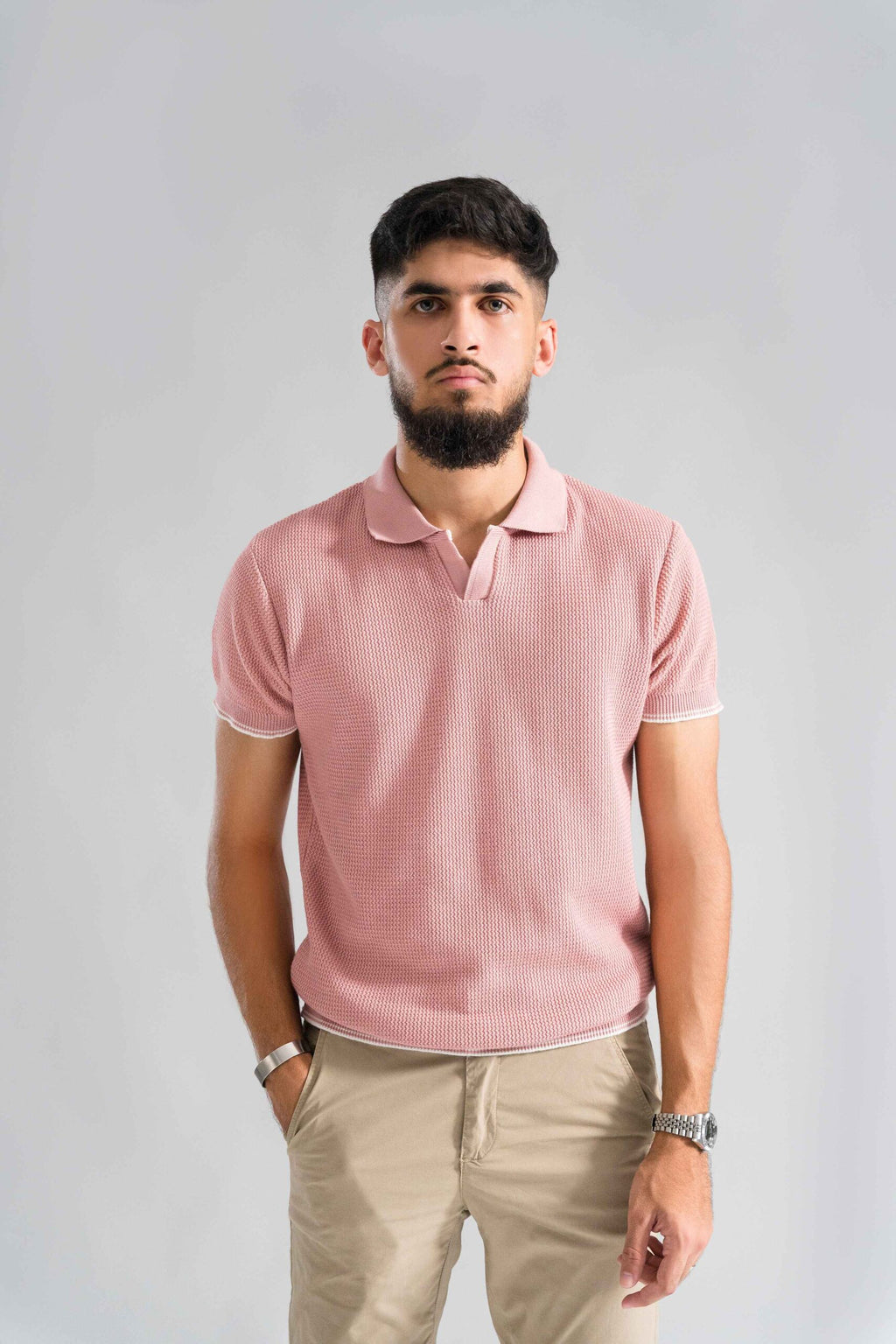 Front view of Wear Anarchy Pink Knitted Polo for men with open collar, short sleeves and textured knit finish