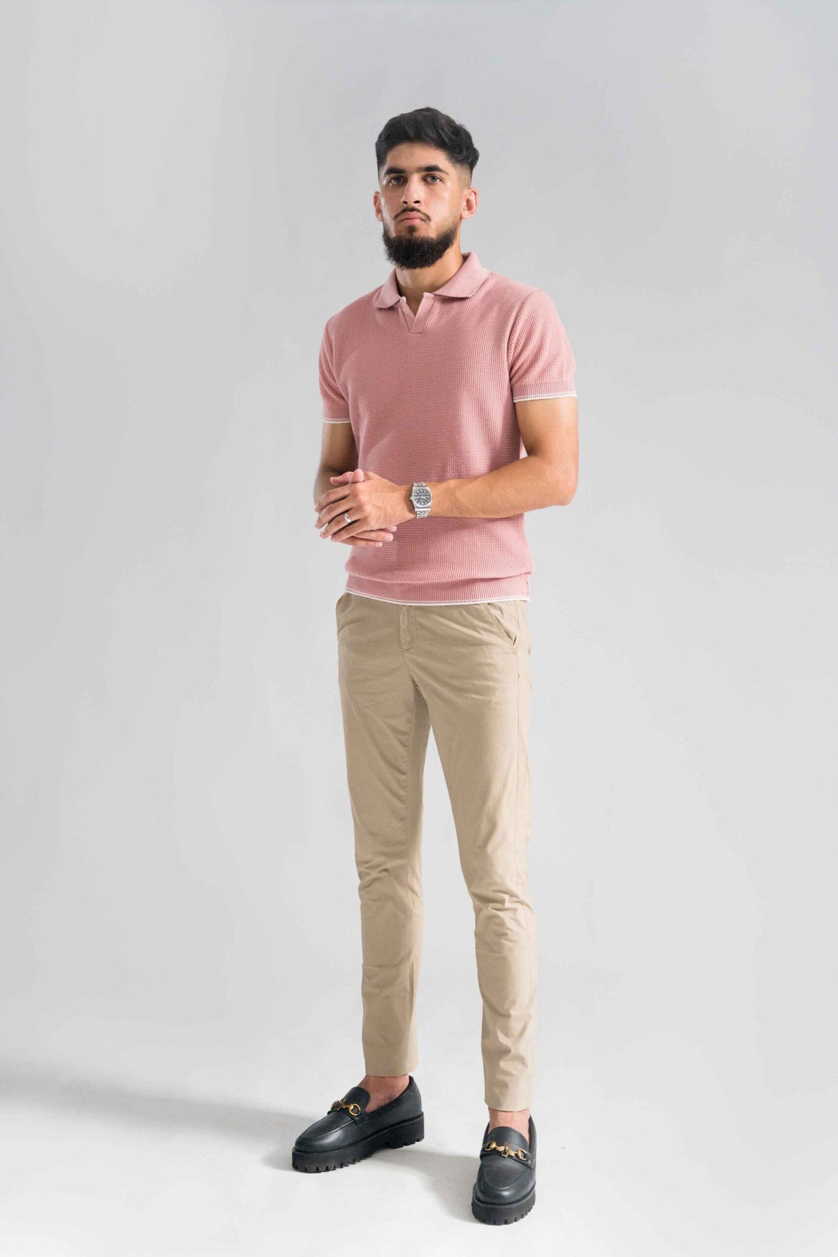 Wear Anarchy Pink Knitted Polo for men styled with beige trousers and black loafers