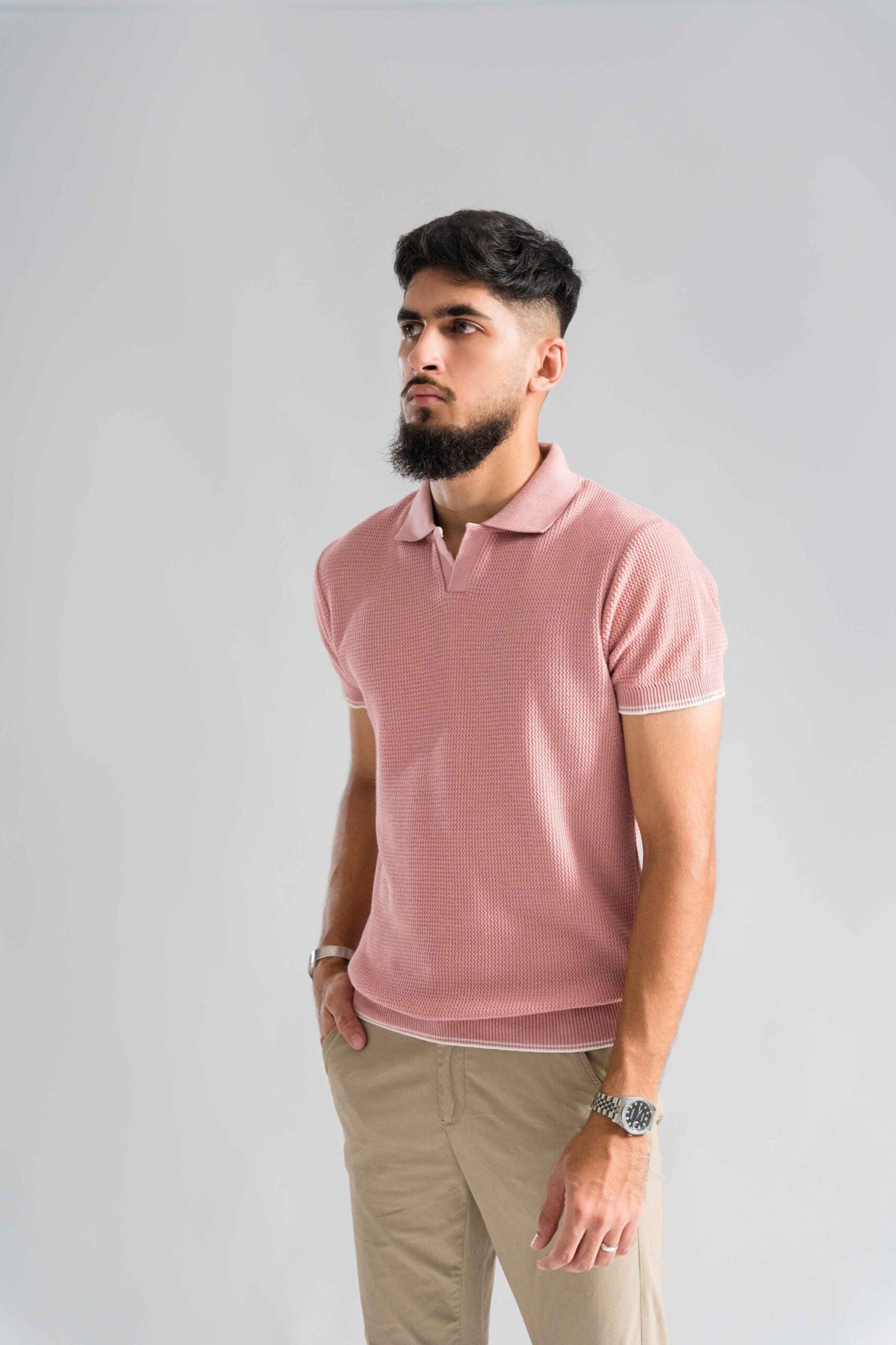 Wear Anarchy Pink Knitted Polo for men with textured knit fabric, short sleeves and open collar