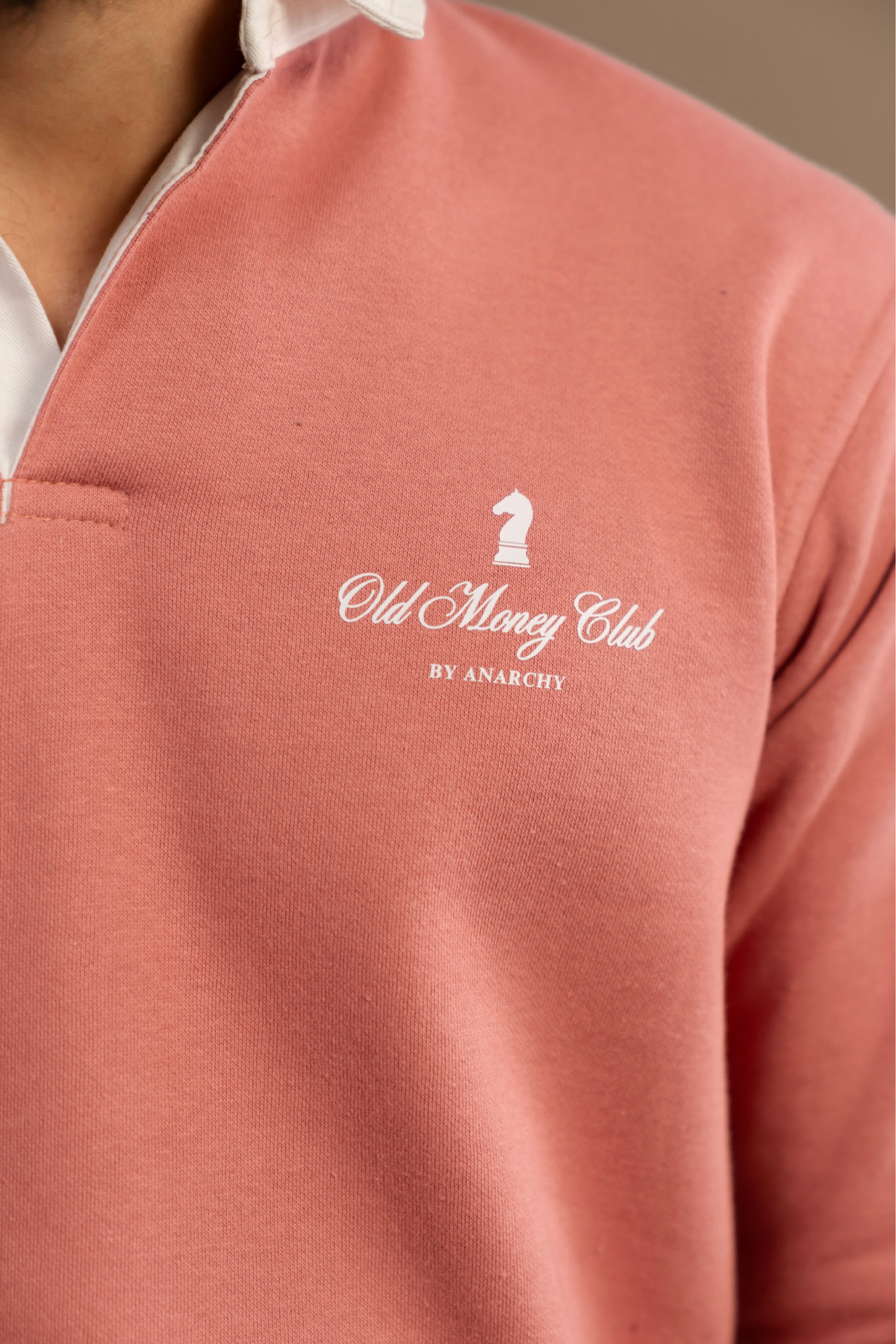 Close-up of Wear Anarchy Pink Rugby Sweatshirt showing Old Money Club embroidered chest logo