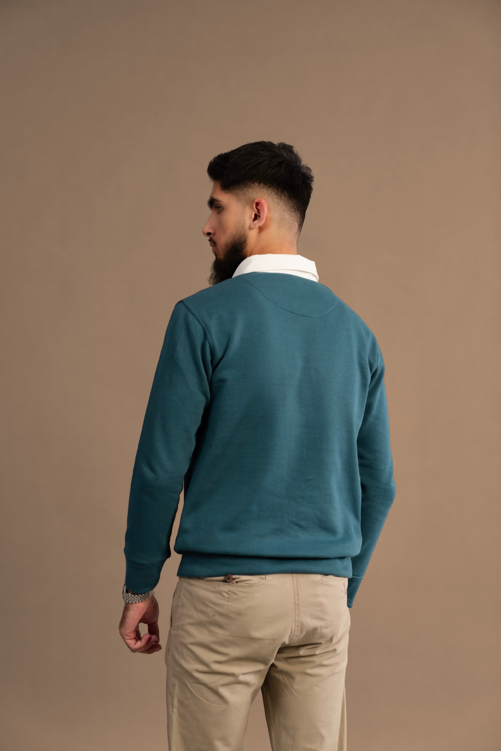 Back view of Wear Anarchy Teal Rugby Sweatshirt for men showing white contrast collar, long sleeves and ribbed hem