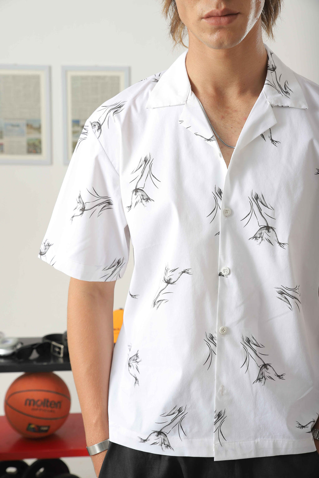 Close-up of Wear Anarchy white camp collar shirt for men with black botanical print and button-front design