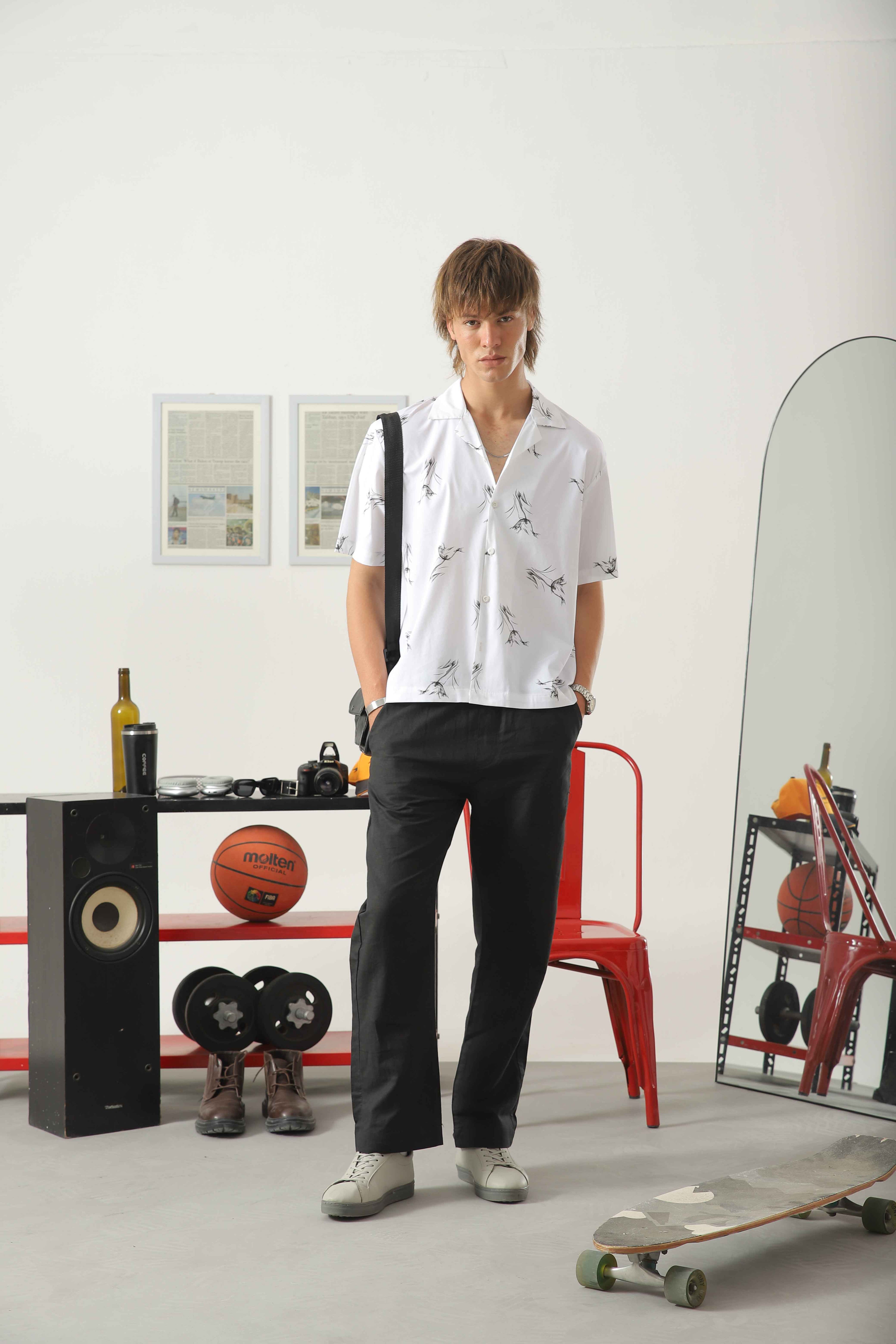 Wear Anarchy white printed camp collar shirt for men styled with black trousers and casual sneakers